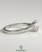 Kynora CJ 2ct round claw solitaire engagement ring with flat band and cathedral high setting, showcasing a sparkling diamond.