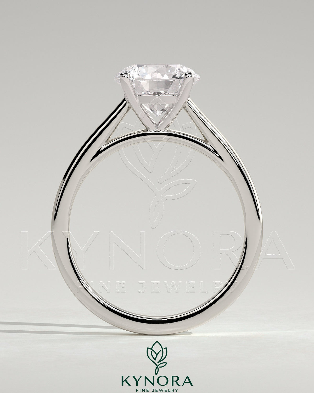 Kynora CJ 2ct round claw solitaire engagement ring with flat band and cathedral high setting, showcasing a sparkling center diamond.