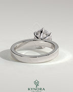 Kynora CJ 2ct round claw solitaire engagement ring with flat cigar band and hidden halo in silver metal.