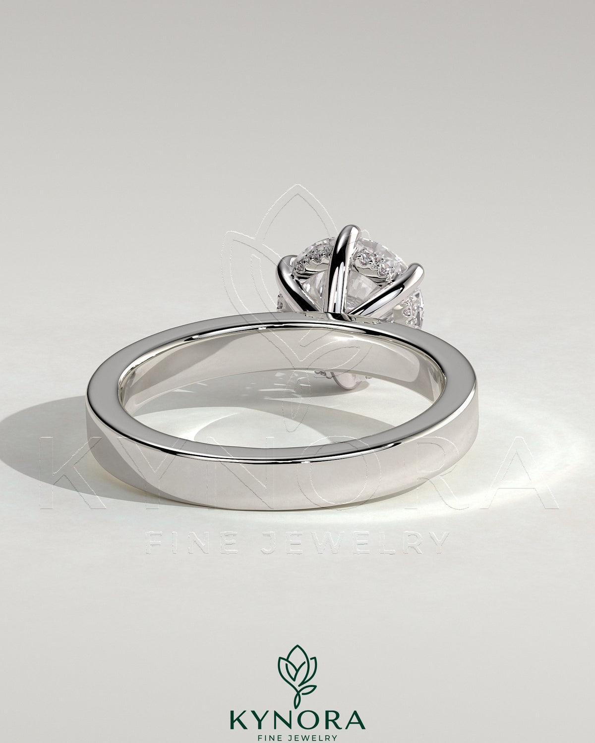 Kynora CJ 2ct round claw solitaire engagement ring with flat cigar band and hidden halo in silver metal.