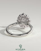 Kynora CJ 2ct round claw solitaire engagement ring with graduating halo, micropave bead set band, and tapered band design.