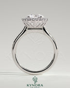 Kynora CJ 2ct round claw solitaire engagement ring with graduating halo, bead set micropave accents, and tapered band.
