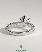Two-carat round diamond claw solitaire engagement ring with half eternity band by Kynora CJ, showcasing sparkling diamonds and elegant design.