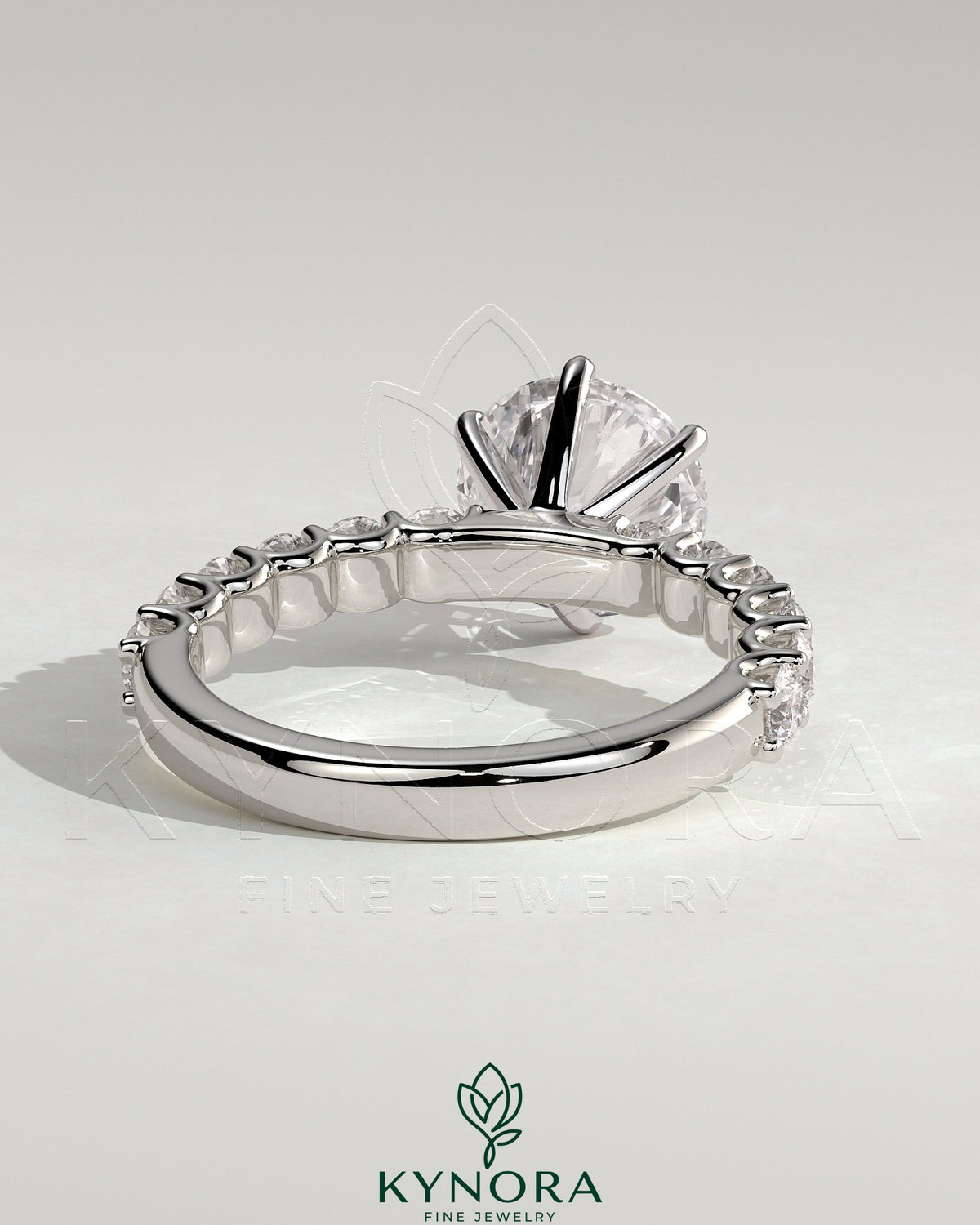Two-carat round diamond claw solitaire engagement ring with half eternity band by Kynora CJ, showcasing sparkling diamonds and elegant design.
