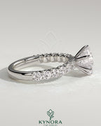 Kynora CJ 2ct round claw solitaire engagement ring with half eternity band, featuring a sparkling central diamond and elegant design.