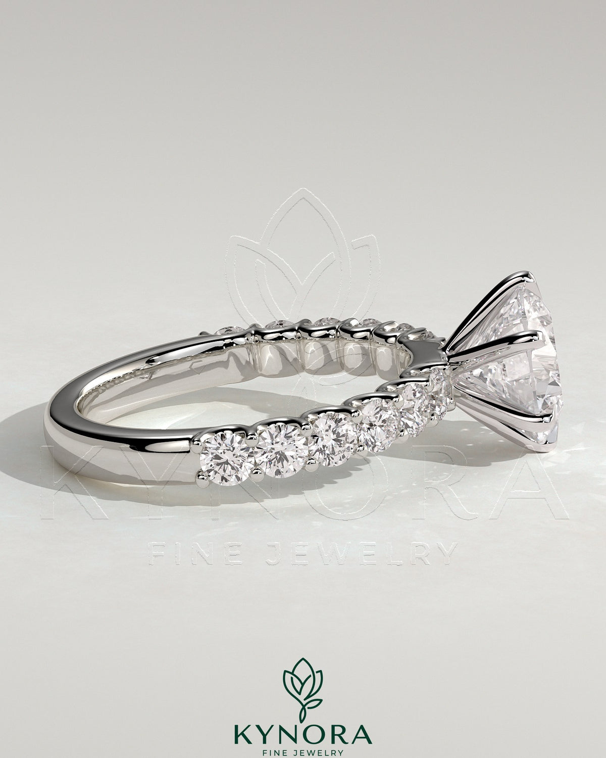 Kynora CJ 2ct round claw solitaire engagement ring with half eternity band, featuring a sparkling central diamond and elegant design.