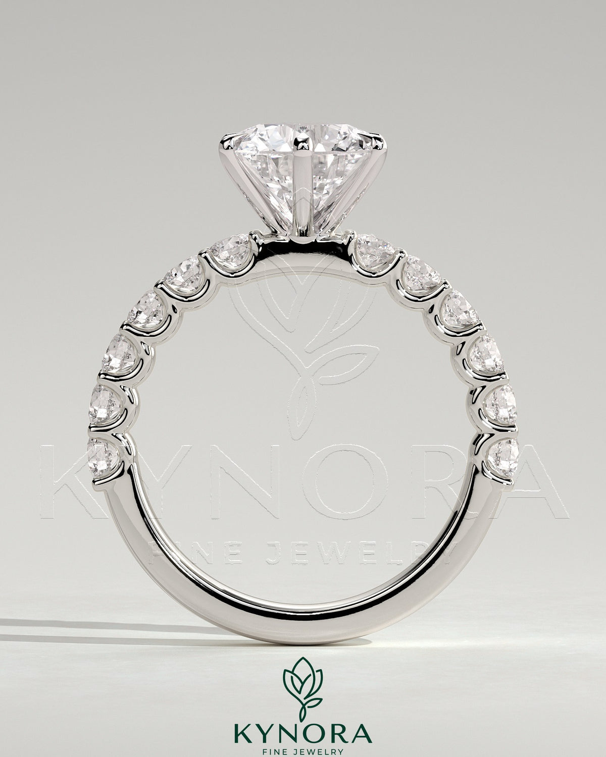 Kynora CJ 2ct round claw solitaire engagement ring with half eternity band, featuring a sparkling central diamond and elegant design.