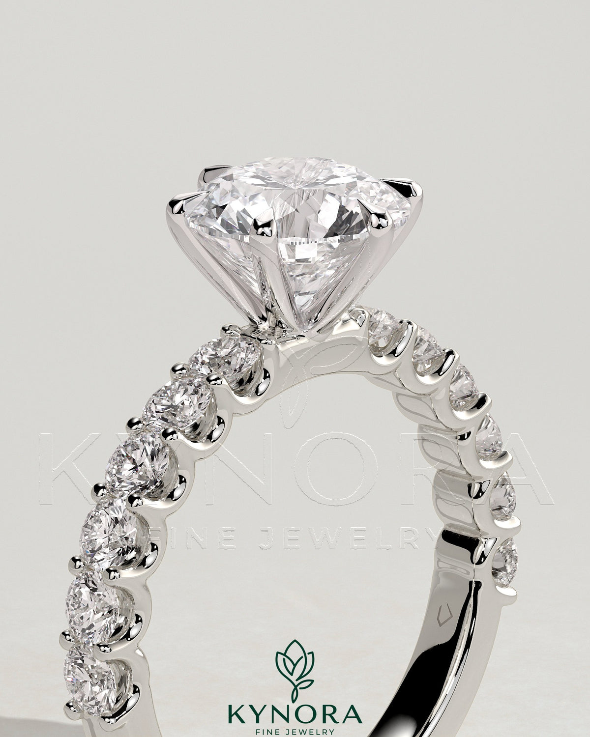 Kynora CJ 2ct round claw solitaire engagement ring with half eternity band, showcasing sparkling diamond setting and elegant design.