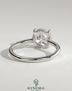 Kynora CJ 2ct round claw solitaire engagement ring with hidden halo and floating cathedral low setting, showcasing intricate metalwork.