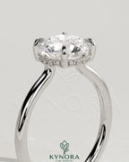 Kynora CJ 2ct round claw solitaire engagement ring with hidden halo and floating cathedral low setting, showcasing diamond details.