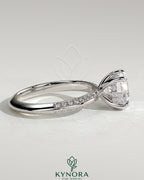 Kynora CJ 2ct round claw solitaire engagement ring with hidden halo and knife edge pave band, sterling silver jewelry.