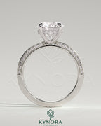 Kynora CJ 2ct round claw solitaire engagement ring with hidden halo and knife edge pave band, featuring sparkling diamond details.