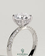 Kynora CJ 2ct round claw solitaire engagement ring with hidden halo and knife edge pave band, elegant and sparkling jewelry piece.