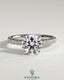 Kynora CJ 2ct round claw solitaire engagement ring with hidden halo and pavé band, featuring sparkling diamond details.