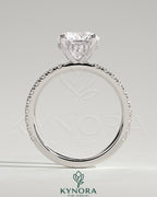 Kynora CJ 2ct round claw solitaire engagement ring with hidden halo and pavé band, showcasing elegant diamond setting and craftsmanship.
