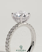 Kynora CJ 2ct round claw solitaire engagement ring with hidden halo and pave band, showcasing elegant diamond setting.