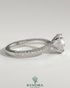 Kynora CJ 2ct round claw solitaire engagement ring with hidden halo and triple pave band, elegant and sparkling jewelry piece.