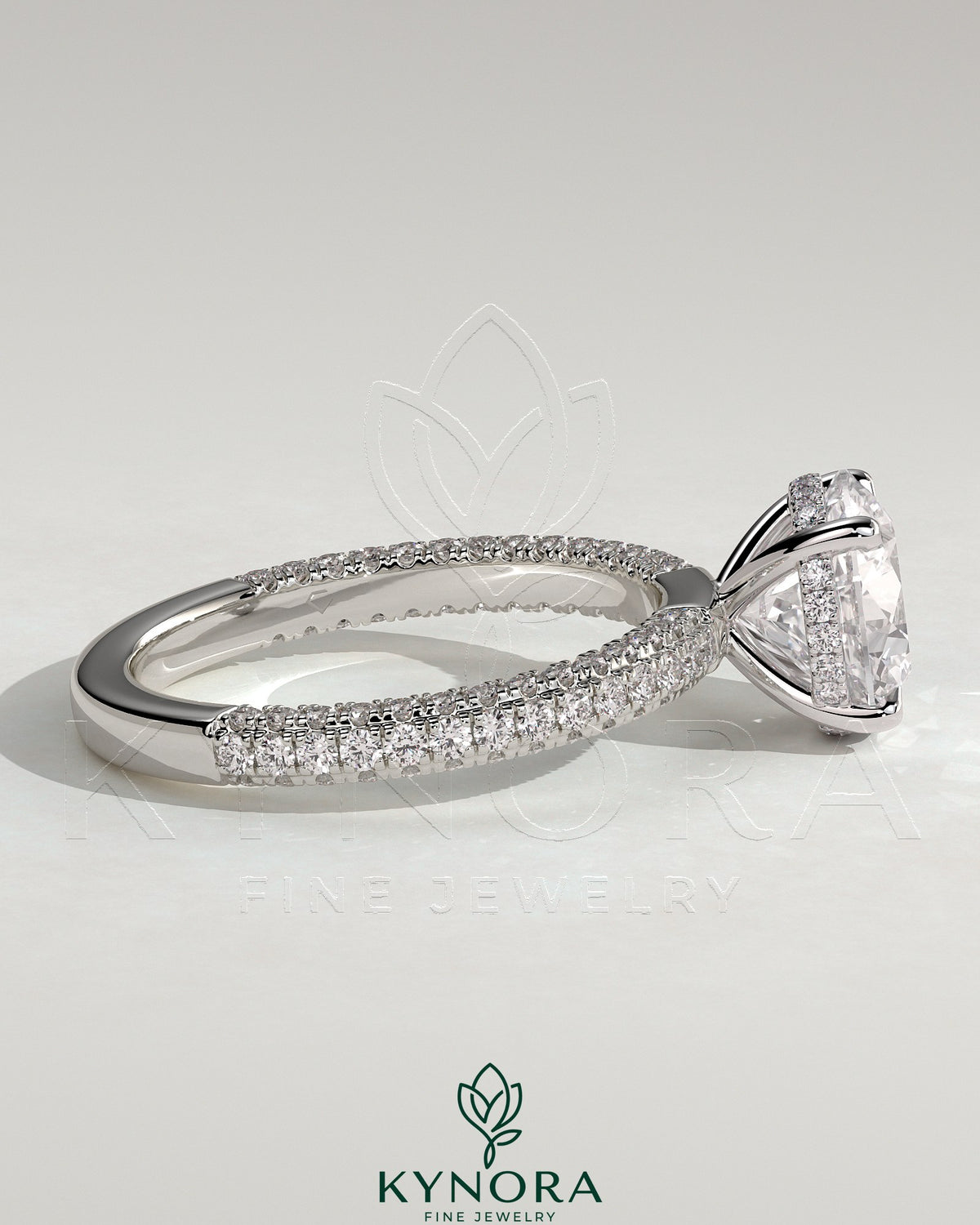 Kynora CJ 2ct round claw solitaire engagement ring with hidden halo and triple pave band, elegant and sparkling jewelry piece.