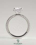 Kynora CJ 2ct round claw solitaire engagement ring with hidden halo and triple pave band, featuring sparkling diamond details.