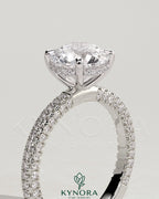 Kynora CJ 2ct round claw solitaire engagement ring with hidden halo and triple pave band, showcasing elegant diamond design.