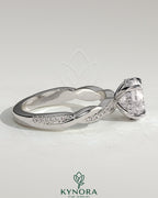 Kynora CJ 2ct round claw solitaire engagement ring with hidden halo and twisted pave band, showcasing elegant diamond setting.