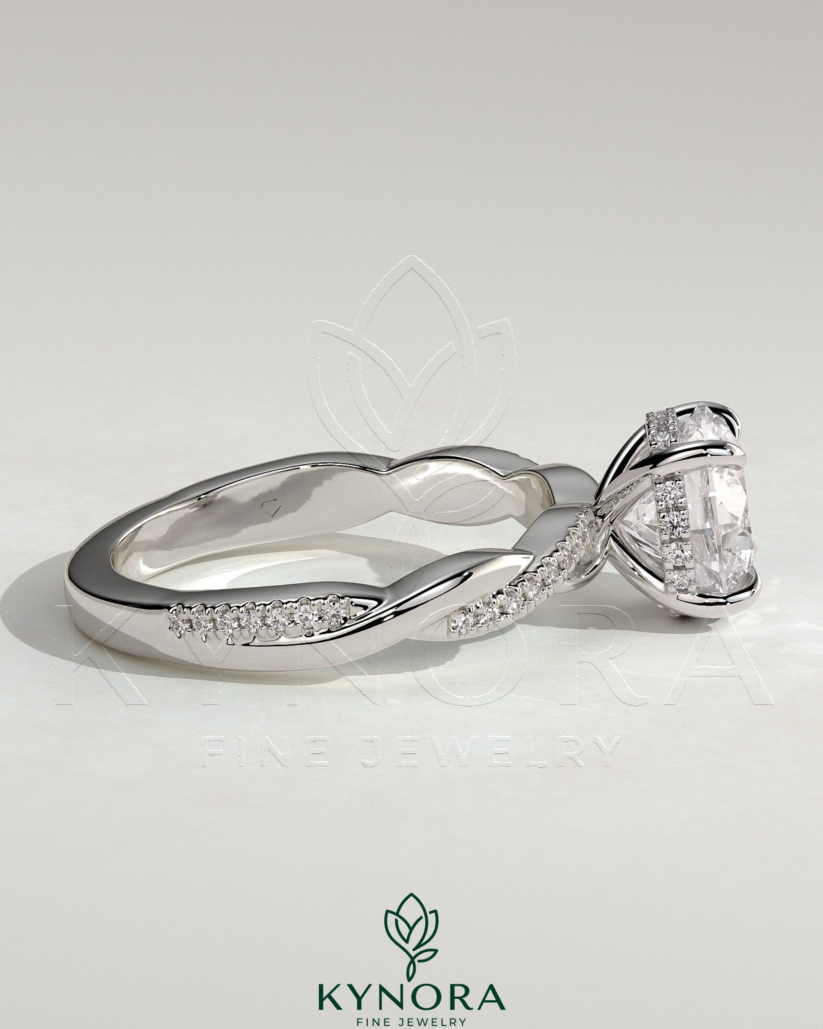 Kynora CJ 2ct round claw solitaire engagement ring with hidden halo and twisted pave band, showcasing elegant diamond setting.