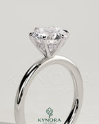 Kynora CJ 2ct round claw solitaire engagement ring with hidden halo, showcasing a sparkling central diamond and elegant design