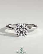 Kynora CJ 2ct round claw solitaire engagement ring with hidden halo, showcasing sparkling diamond centerpiece and elegant design.