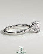 Kynora CJ 2ct round cut solitaire engagement ring with hidden halo, featuring a sleek platinum band and sparkling center stone.