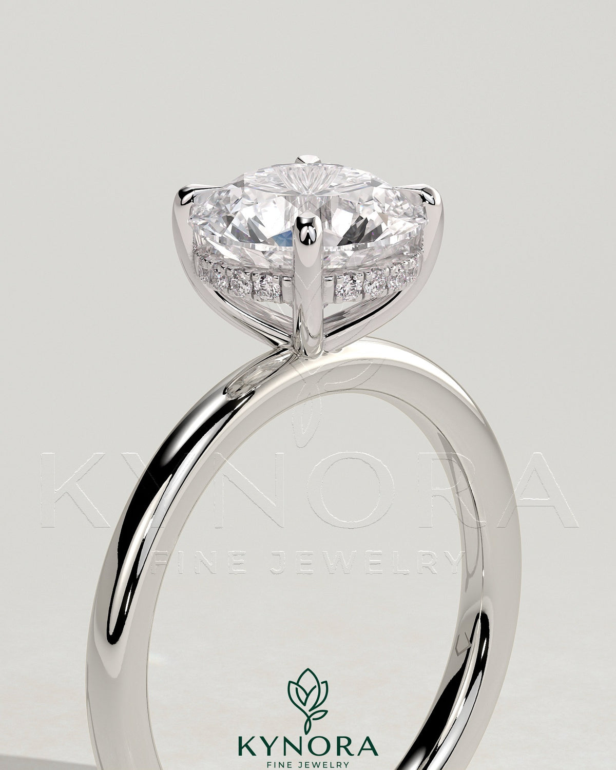 Kynora CJ 2ct round claw solitaire engagement ring with hidden halo, featuring a sparkling central diamond and elegant design.