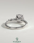 Kynora CJ 2ct round claw solitaire engagement ring with hidden halo, marquise accents, and cathedral high setting.