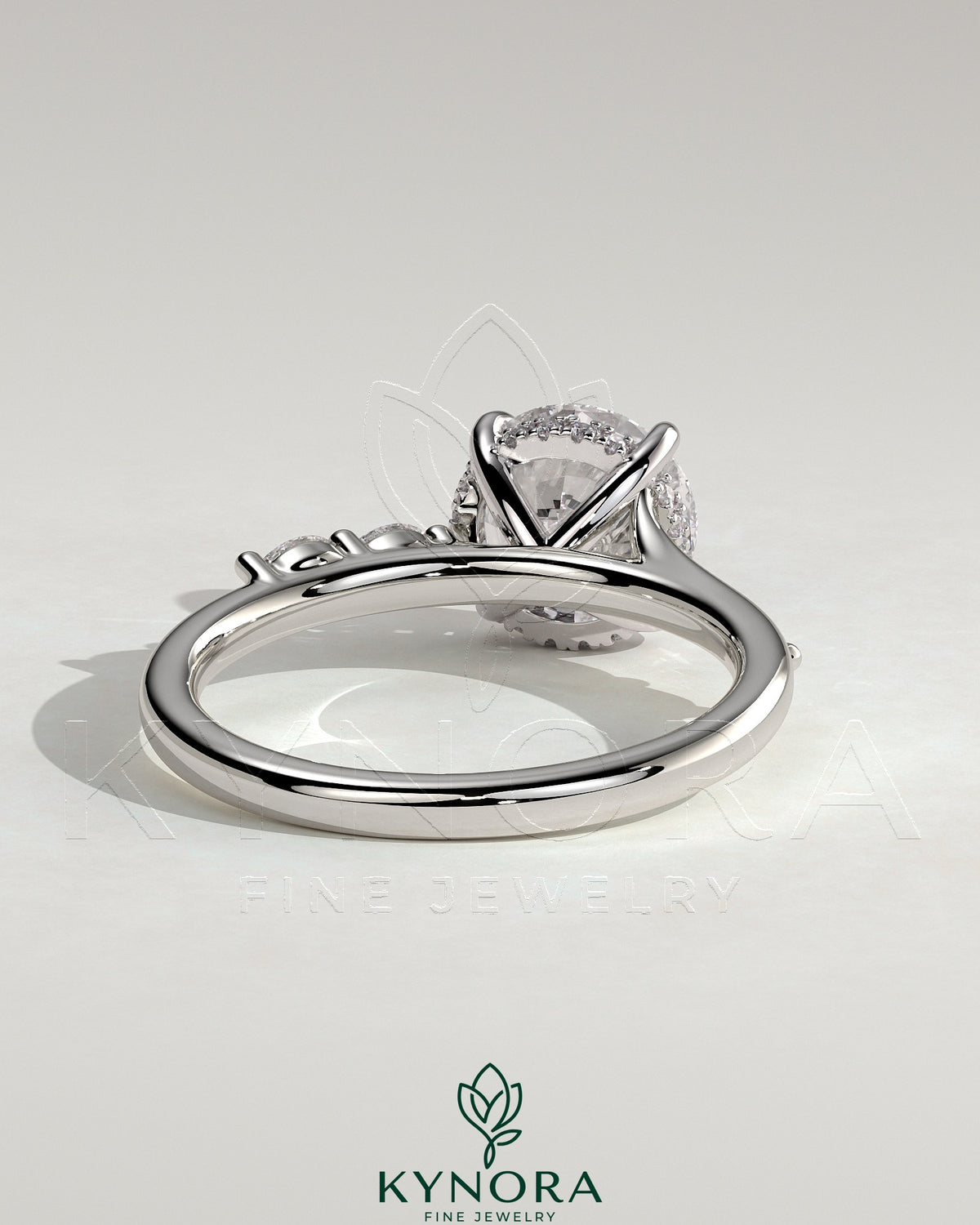 Kynora CJ 2ct round claw solitaire engagement ring with hidden halo, marquise accents, and cathedral high setting.