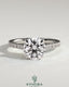 Kynora CJ 2ct round solitaire engagement ring with hidden halo, pave band, and cathedral high setting, showcasing intricate jewelry design.