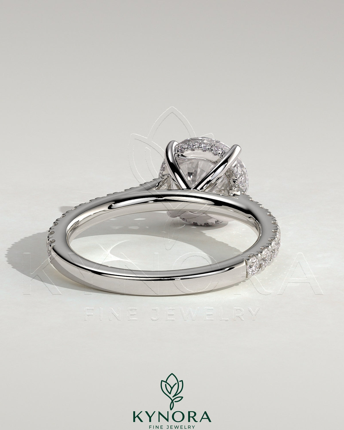 Kynora CJ 2ct round claw solitaire engagement ring with hidden halo, pave band, and cathedral high setting.