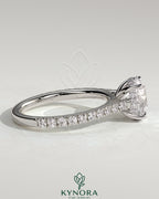 Kynora CJ 2ct round claw solitaire engagement ring with hidden halo, pave band, and cathedral high setting showcasing sparkling detail.