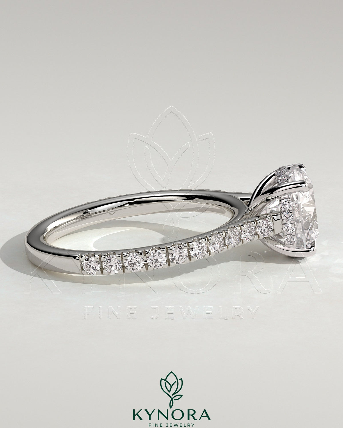 Kynora CJ 2ct round claw solitaire engagement ring with hidden halo, pave band, and cathedral high setting showcasing sparkling detail.