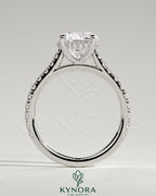 Kynora CJ 2ct round claw solitaire engagement ring with hidden halo, pave band, and cathedral high setting showcasing intricate design.