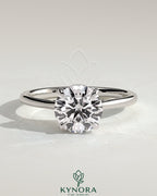 Kynora CJ 2ct round claw solitaire engagement ring with hidden halo, tapered band, and cathedral high setting.