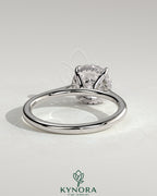 Kynora CJ 2ct round claw solitaire engagement ring with hidden halo, tapered band, cathedral high setting showcasing the ring.
