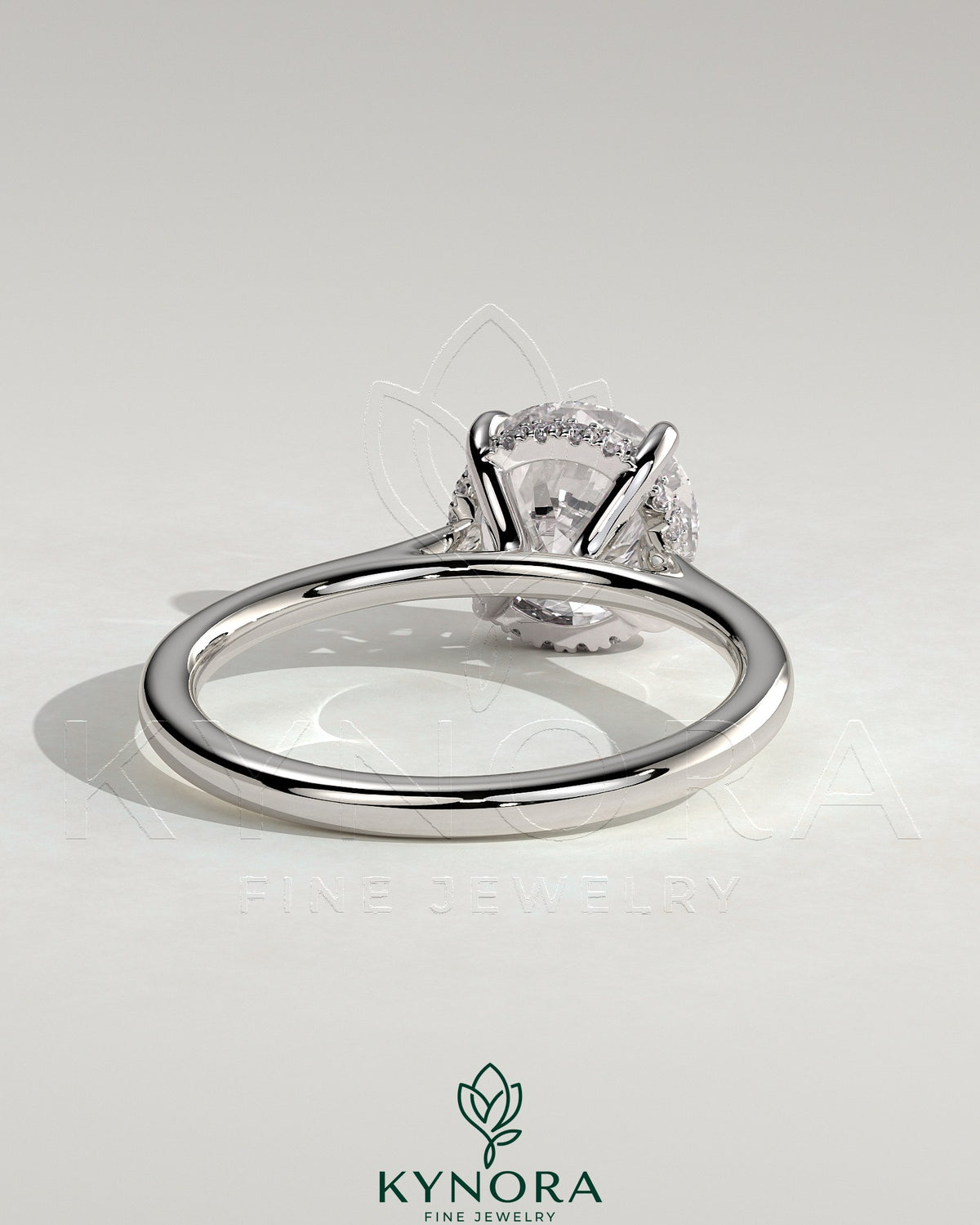 Kynora CJ 2ct round claw solitaire engagement ring with hidden halo, tapered band, cathedral high setting showcasing the ring.