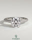 Kynora CJ 2ct round claw solitaire engagement ring with hidden halo, triple pave band, cathedral high setting, showcasing elegant design.