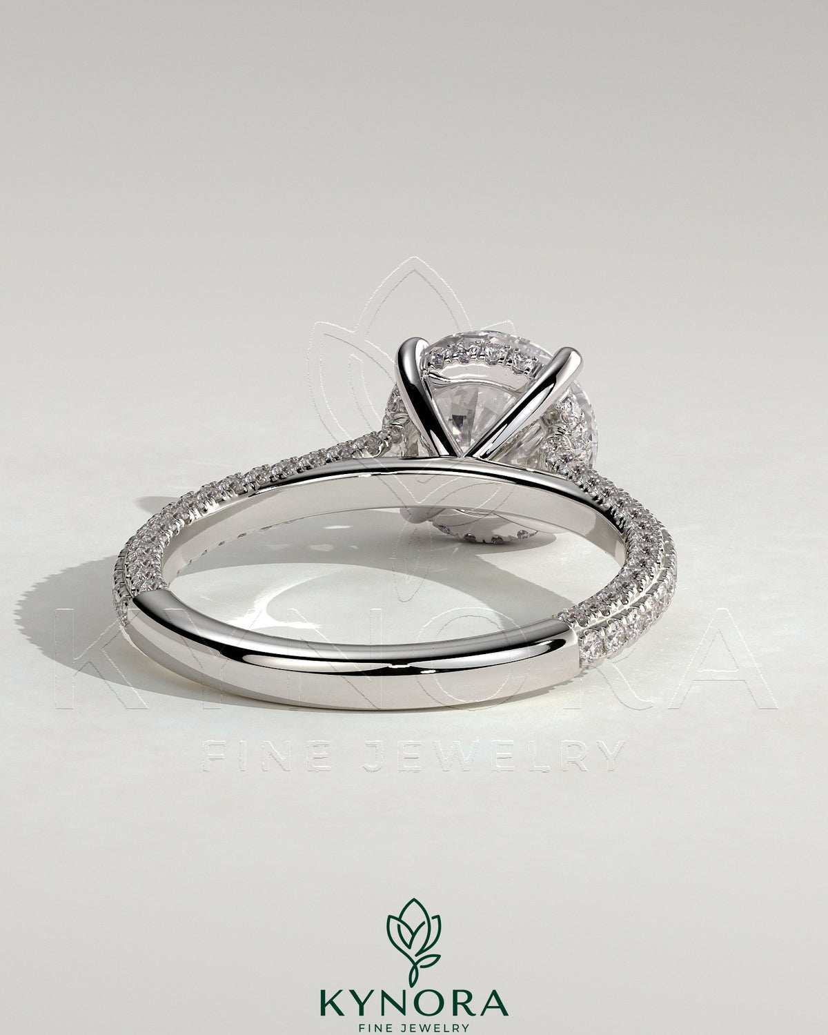 Kynora CJ 2ct round claw solitaire engagement ring with hidden halo, triple pave band, and cathedral high setting.