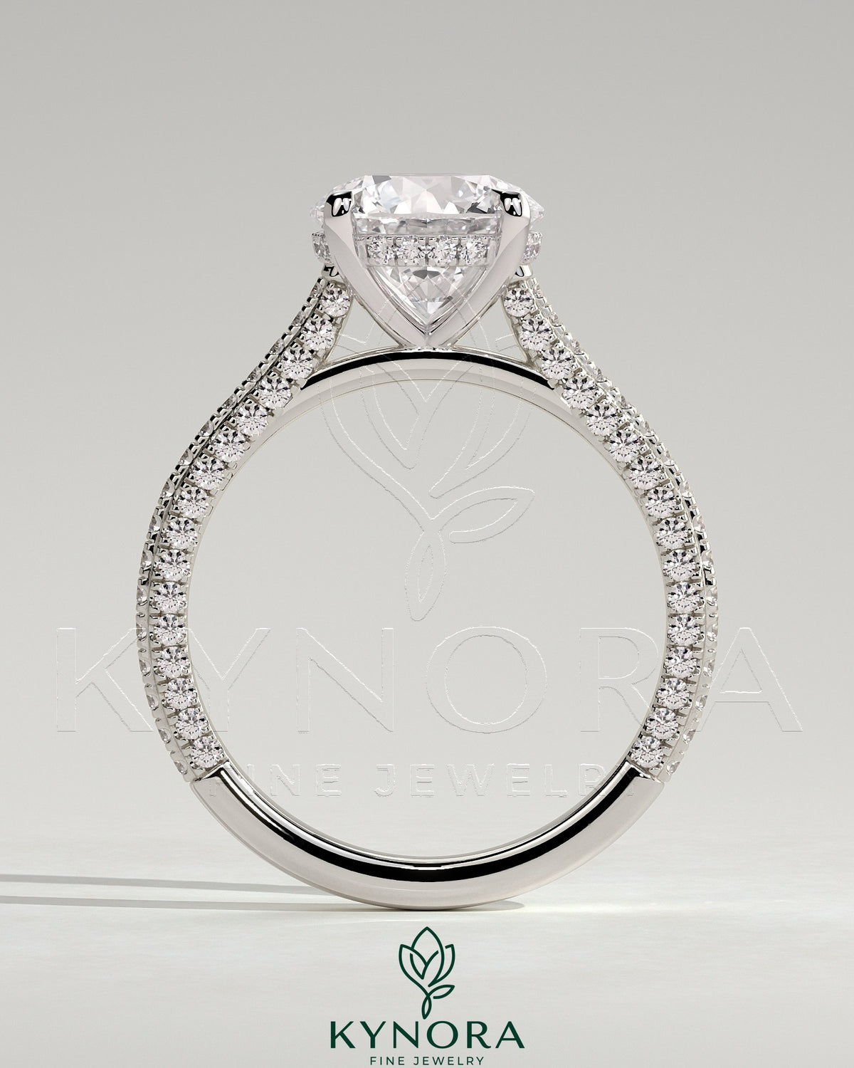 Kynora CJ 2ct round claw solitaire engagement ring with hidden halo, triple pave band, and cathedral high setting.