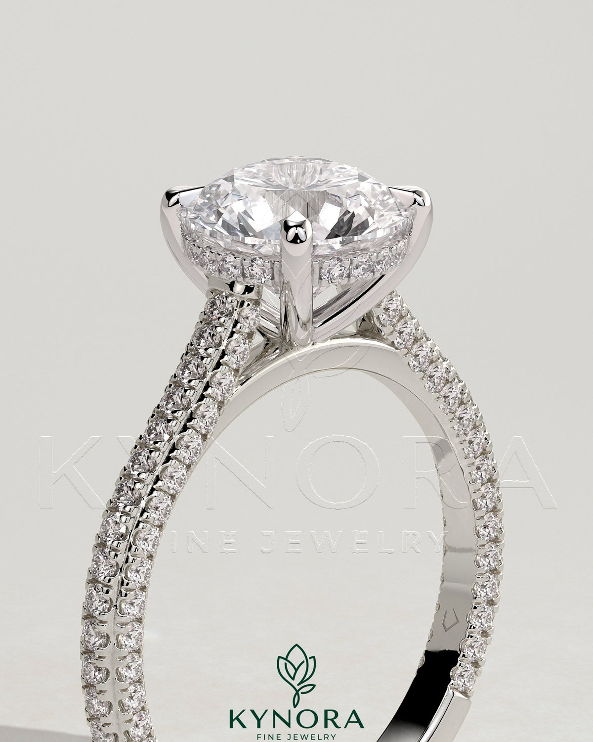 Kynora CJ 2ct round claw solitaire engagement ring with hidden halo, triple pave band, and cathedral high setting.
