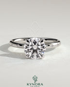 Kynora CJ 2ct round claw solitaire engagement ring with inset round accent stones, elegant and sparkling jewelry piece