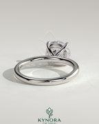 Kynora CJ 2ct round claw solitaire engagement ring with inset round accent stones, showcasing elegant jewelry design.
