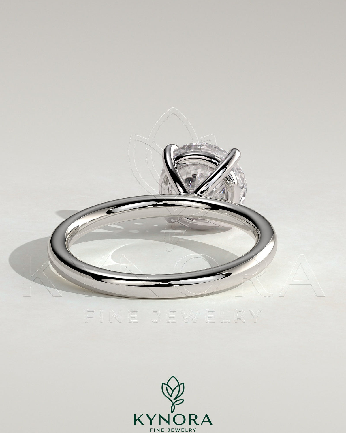 Kynora CJ 2ct round claw solitaire engagement ring with inset round accent stones, showcasing elegant jewelry design.