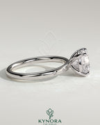 Kynora CJ 2ct round claw solitaire engagement ring with inset round accent stones, showcasing elegant jewelry design.