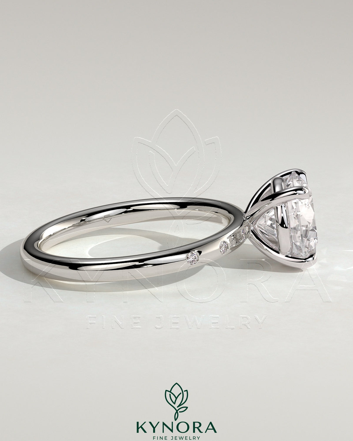 Kynora CJ 2ct round claw solitaire engagement ring with inset round accent stones, showcasing elegant jewelry design.