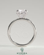 Kynora CJ 2ct round claw solitaire engagement ring with inset round accent stones, showcasing a elegant and sparkling design.
